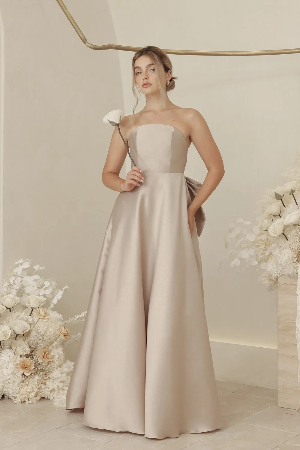 CAROLINE Strapless Curved Neckline Full Length Gown with Bow, Pockets and Covered Buttons (Tan Gazaar)